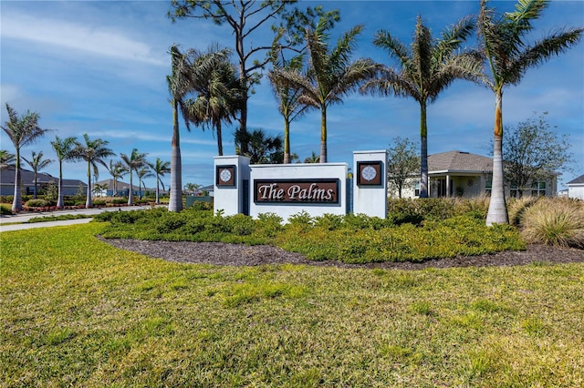 community sign featuring a lawn