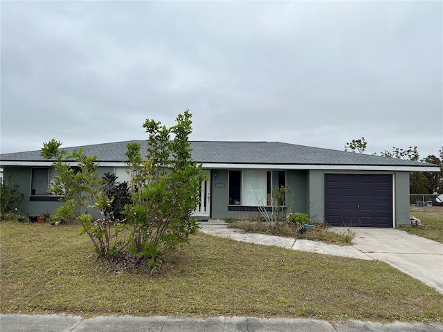 single story home featuring a garage and a front lawn