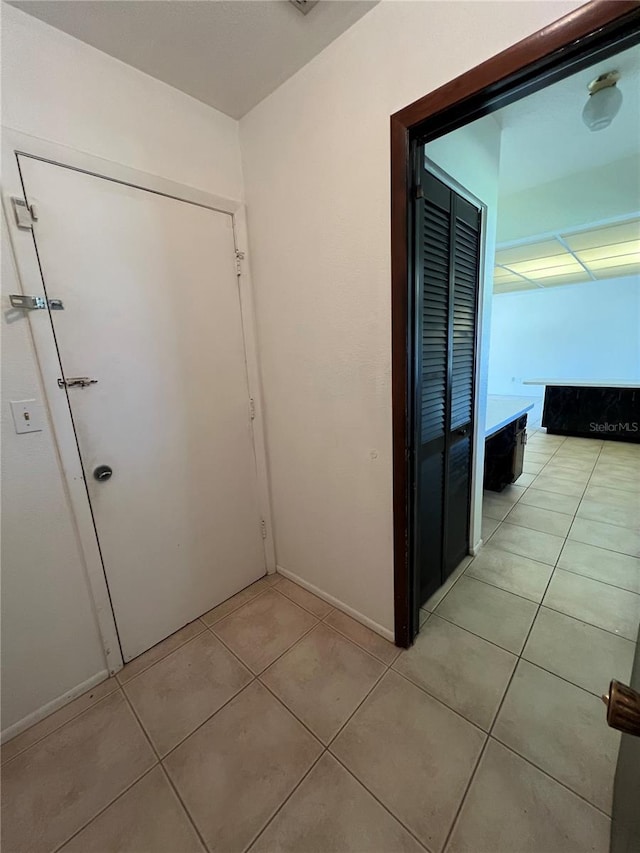 corridor featuring light tile patterned floors