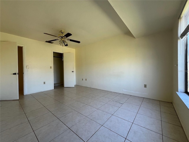 empty room featuring a ceiling fan and light tile patterned floors