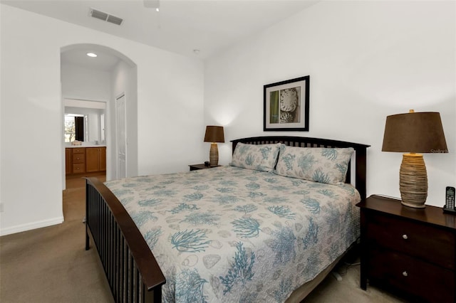 carpeted bedroom featuring a closet and ensuite bathroom