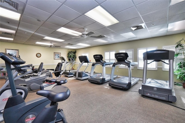 exercise room featuring ceiling fan and a paneled ceiling