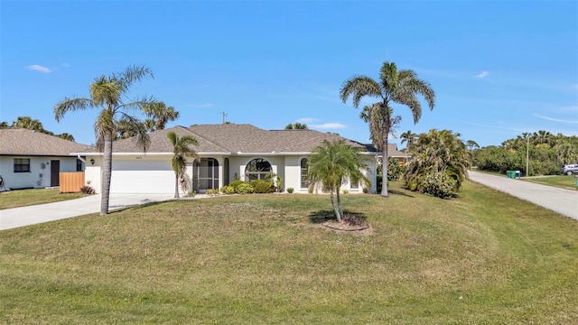 ranch-style home featuring a garage and a front lawn