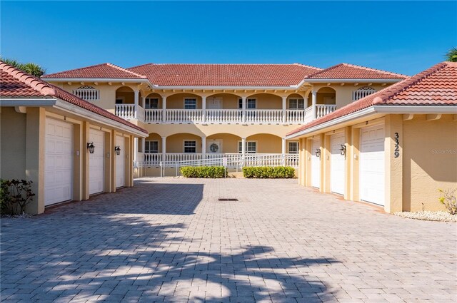 mediterranean / spanish home with a garage