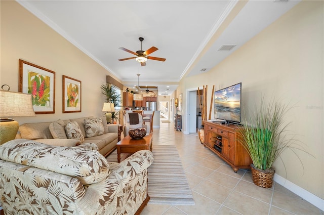 tiled living room with ornamental molding and ceiling fan