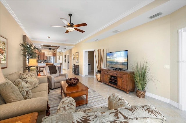 living room with light tile patterned floors, crown molding, and ceiling fan