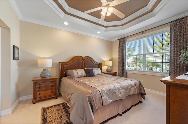 carpeted bedroom featuring a tray ceiling, ornamental molding, and ceiling fan