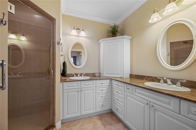 bathroom featuring tile patterned flooring, crown molding, vanity, and a shower with shower door