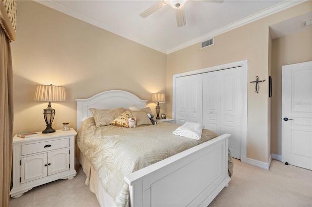 carpeted bedroom with crown molding, a closet, and ceiling fan