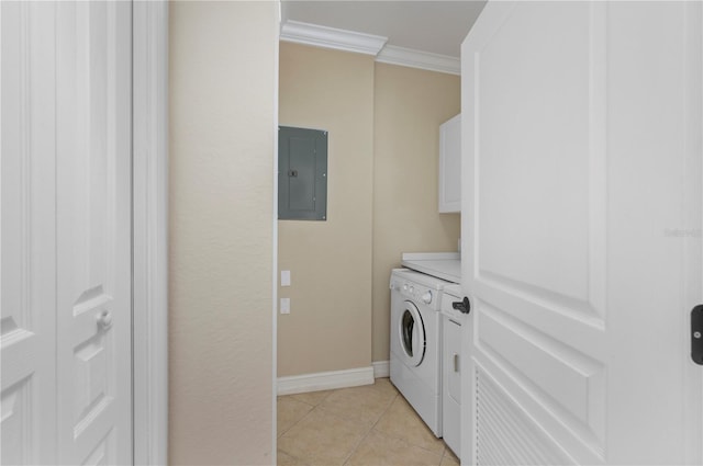 clothes washing area with light tile patterned floors, crown molding, electric panel, and cabinets