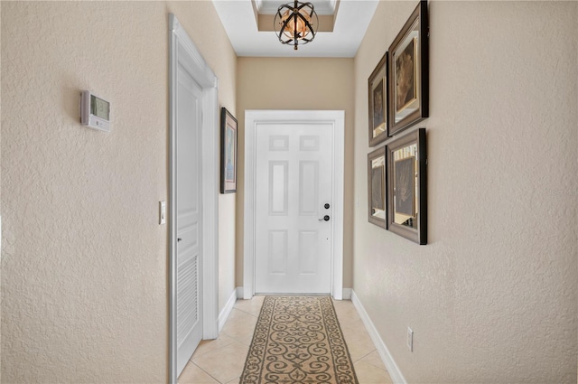 doorway to outside with light tile patterned floors