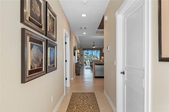 hall with light tile patterned floors