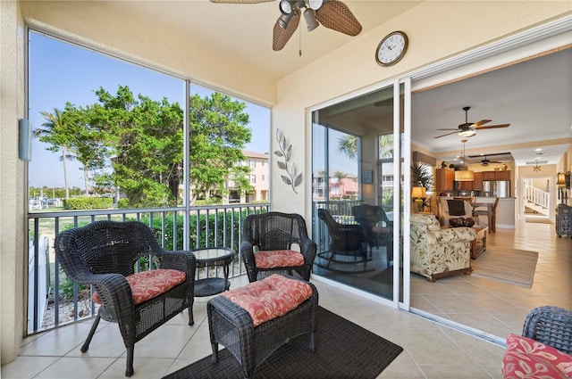 sunroom featuring ceiling fan