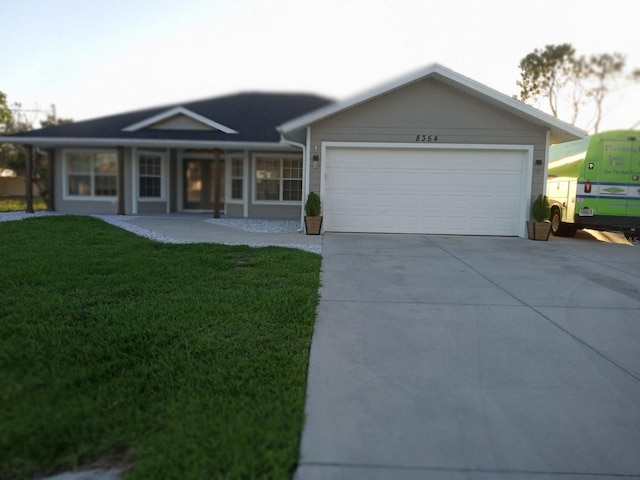 single story home featuring a garage, a front lawn, and a porch