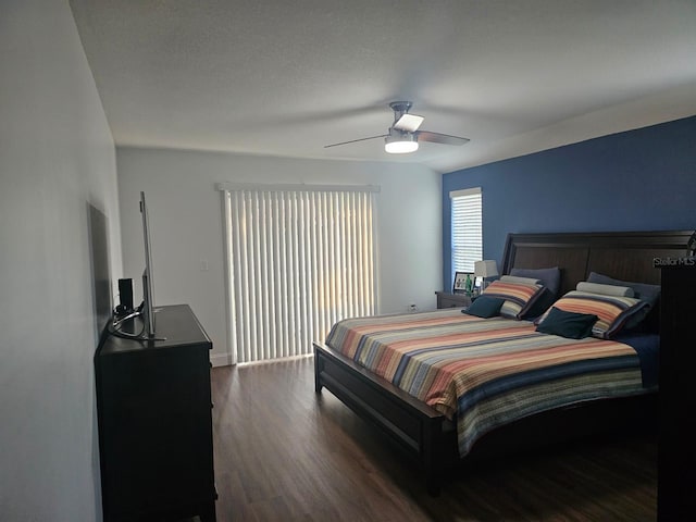 bedroom with ceiling fan and dark hardwood / wood-style floors