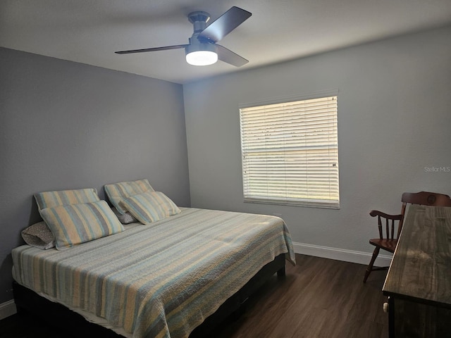 bedroom featuring ceiling fan and dark hardwood / wood-style flooring