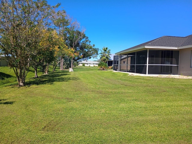 view of yard featuring a sunroom