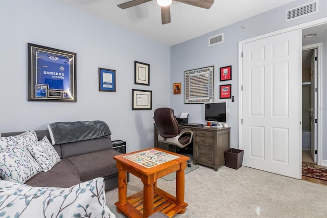 carpeted living room with ceiling fan