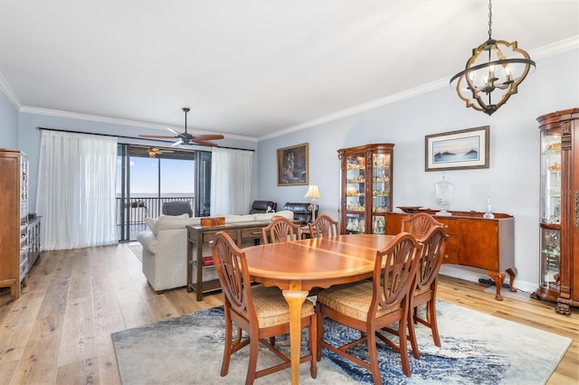 dining space featuring ceiling fan with notable chandelier, ornamental molding, and light hardwood / wood-style floors