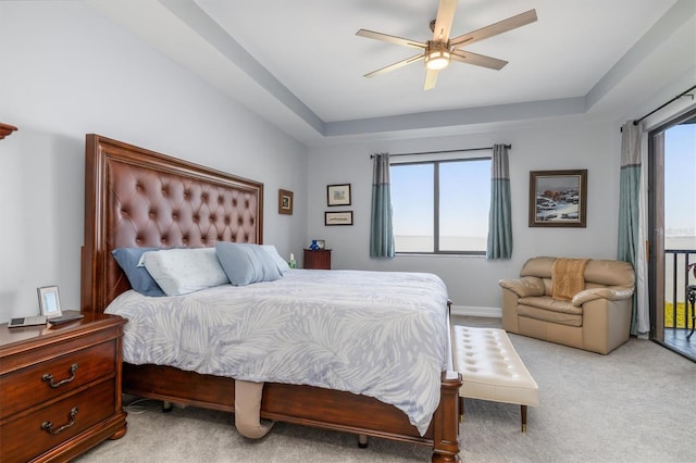 bedroom featuring multiple windows, light colored carpet, access to exterior, and ceiling fan