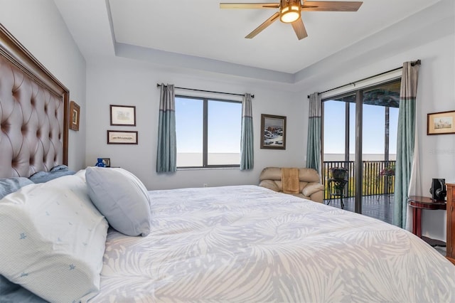 bedroom with multiple windows, access to outside, and ceiling fan