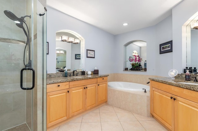 bathroom with tile patterned flooring, vanity, and separate shower and tub