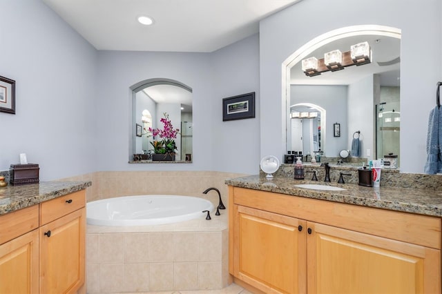 bathroom featuring vanity and plus walk in shower