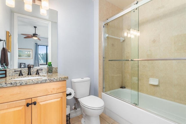 full bathroom with ceiling fan, combined bath / shower with glass door, tile patterned flooring, vanity, and toilet