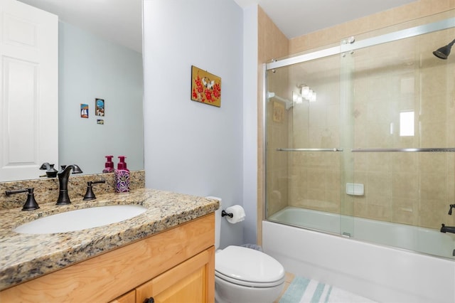 full bathroom with vanity, toilet, and combined bath / shower with glass door