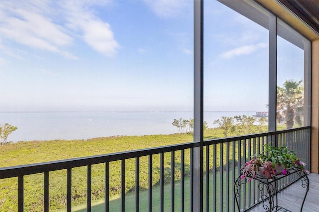 unfurnished sunroom with a water view