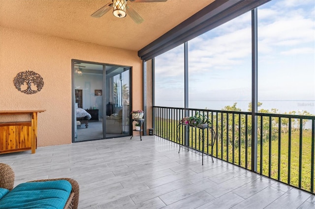 sunroom featuring ceiling fan