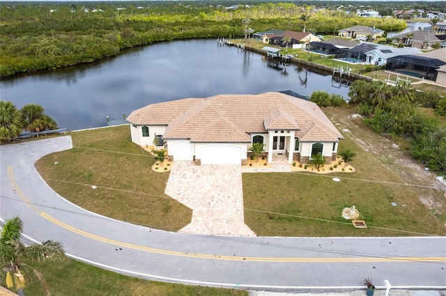 birds eye view of property with a water view