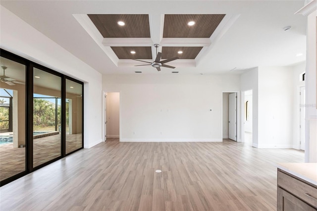 unfurnished living room featuring a towering ceiling, beamed ceiling, coffered ceiling, ceiling fan, and light wood-type flooring