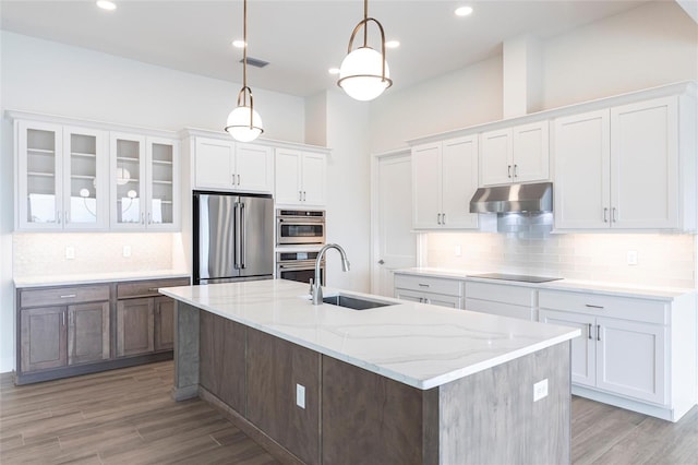 kitchen featuring stainless steel appliances, sink, hanging light fixtures, and white cabinets