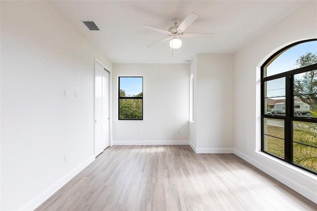 spare room with light hardwood / wood-style flooring and ceiling fan