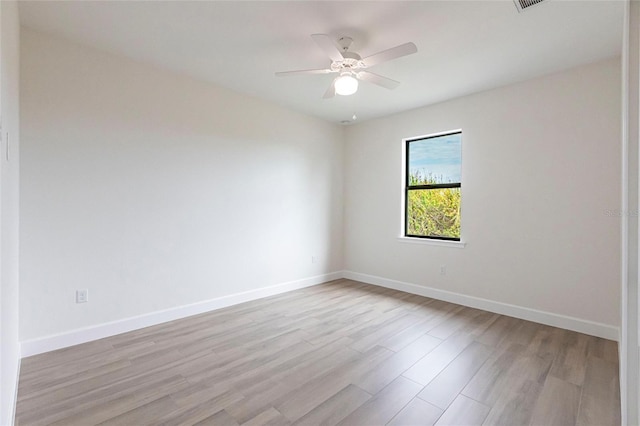 spare room featuring ceiling fan and light wood-type flooring