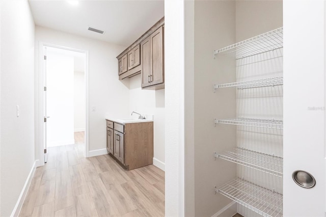 interior space with sink and light hardwood / wood-style flooring