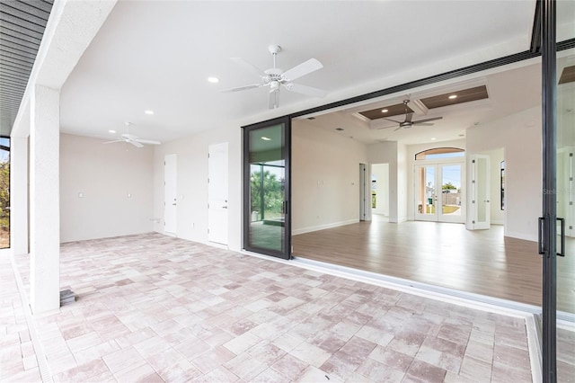 unfurnished room with ceiling fan and french doors