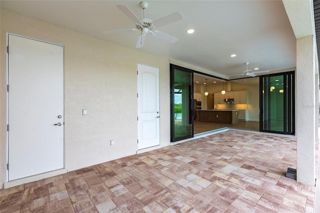 unfurnished living room with ceiling fan