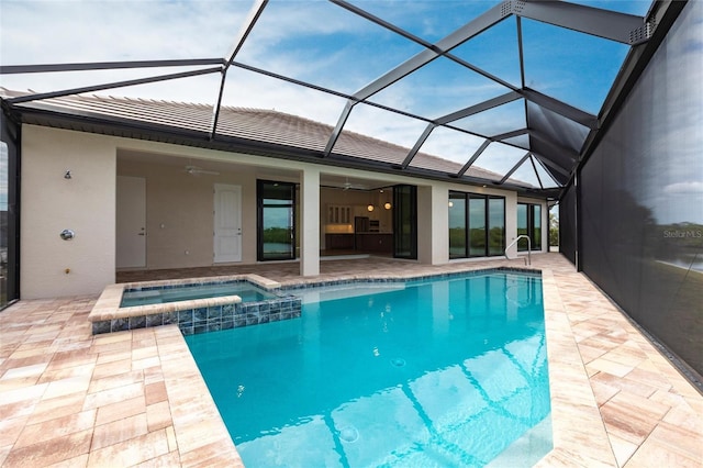 view of pool with an in ground hot tub, a lanai, ceiling fan, and a patio area