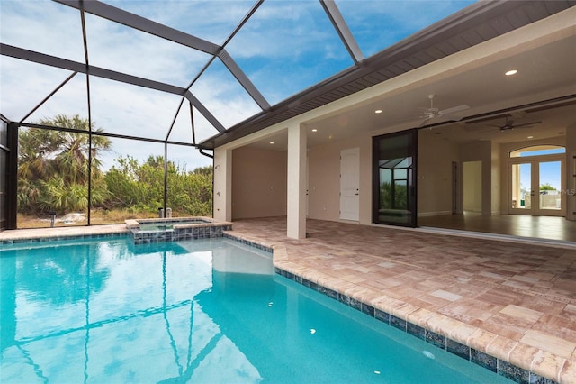 view of pool featuring a lanai, a patio area, ceiling fan, and an in ground hot tub