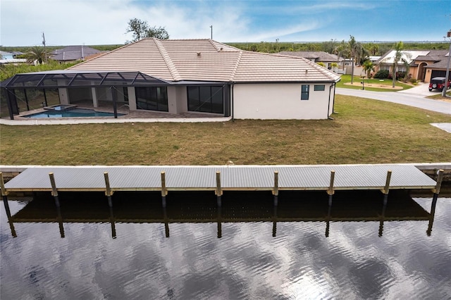 back of property featuring a yard and glass enclosure