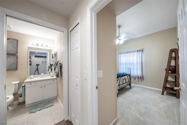 bathroom featuring ceiling fan, vanity, toilet, and tile patterned floors