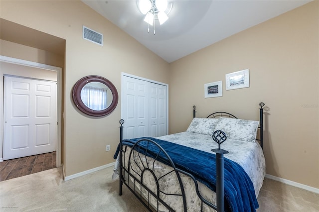 bedroom featuring ceiling fan, a closet, lofted ceiling, and light carpet