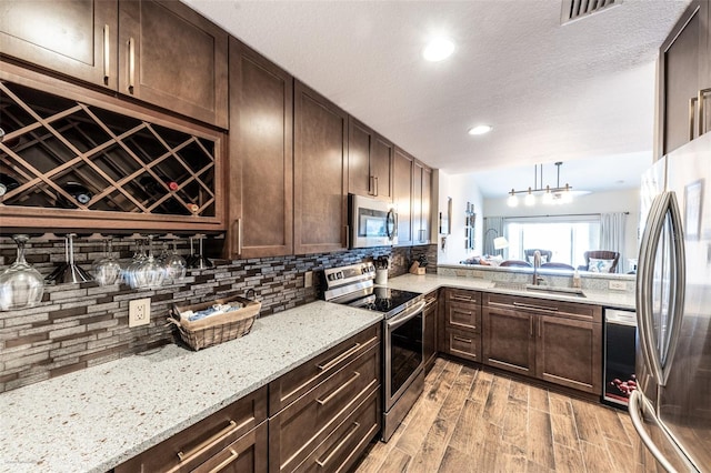 kitchen featuring dark brown cabinetry, sink, and stainless steel appliances