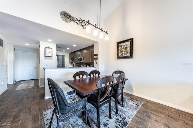 dining room with dark hardwood / wood-style flooring