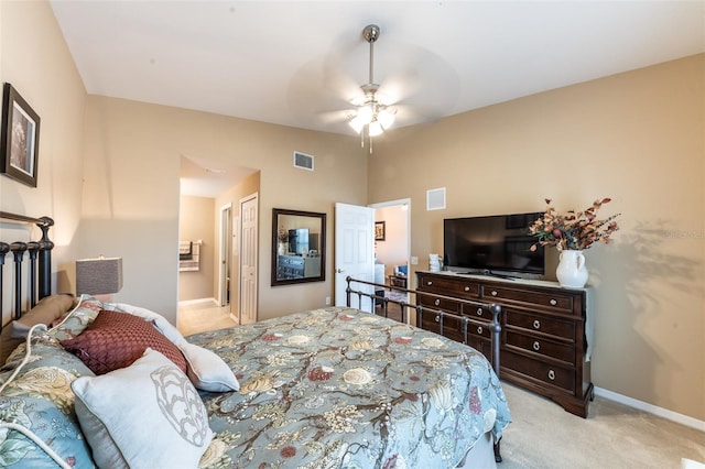 bedroom with ceiling fan, connected bathroom, light carpet, vaulted ceiling, and a closet