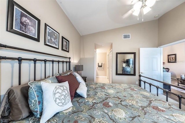 bedroom with vaulted ceiling, ceiling fan, and ensuite bathroom