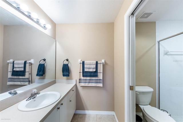 bathroom with vanity, tile patterned flooring, toilet, and walk in shower