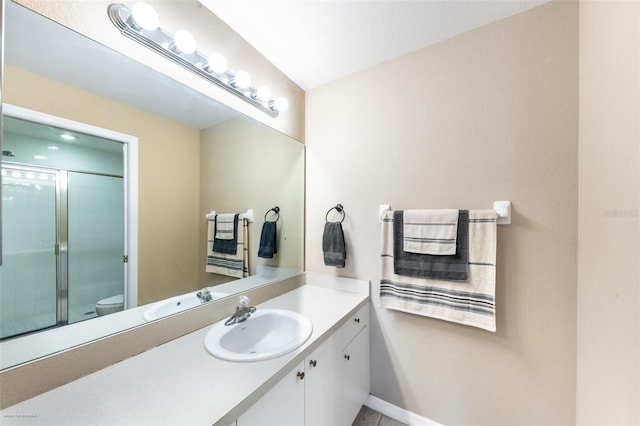 bathroom with walk in shower, vanity, and toilet